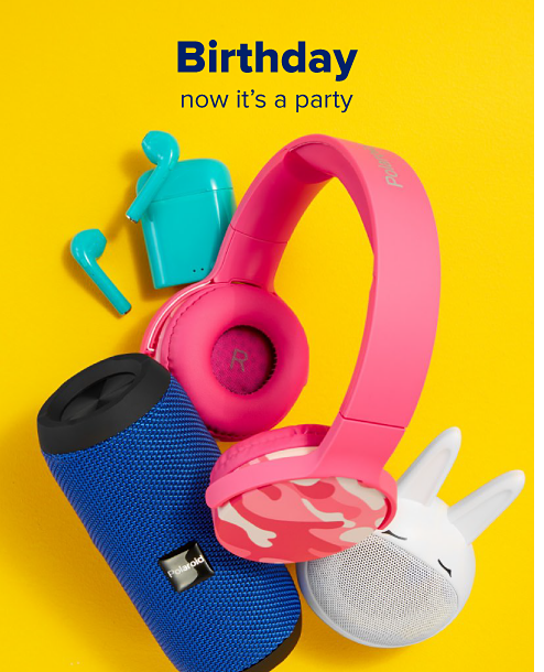 A pair of pink headphones, a blue speaker, a small white speaker and turquiose wireless earbuds. Birthday, now it's a party.