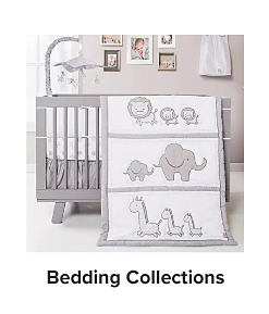 A gray crib with a white and gray baby blanket with lions, elephants and giraffes on it. 