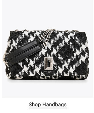 An image of a black and white handbag. Shop handbags. 