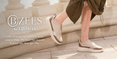 Bzees for LifeStride. Life changing comfort with every step. Perfect for travel and your on the go life. Image of a woman in brown zip up shoes.