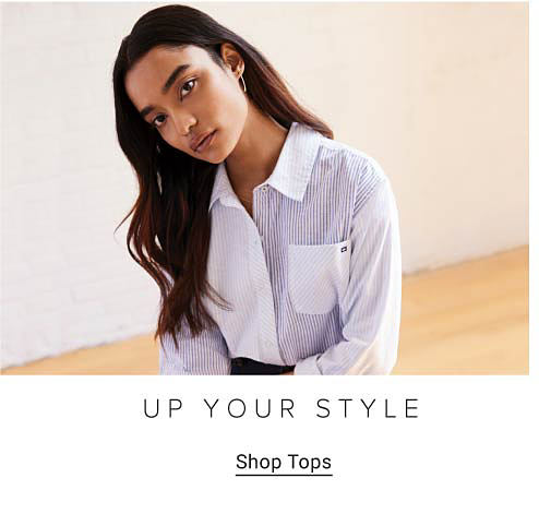 Woman wearing a white and blue pinstripe button down. Up your style. Shop tops.