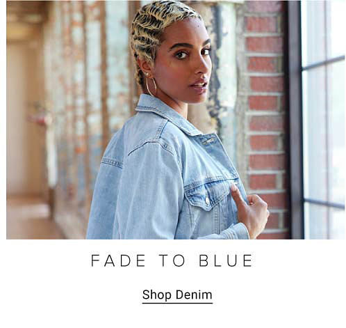 Woman wearing a light blue denim jacket. Fade to blue. Shop denim.