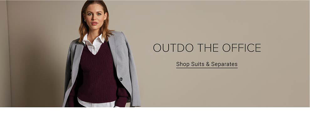 Woman wearing a maroon v-neck sweater over a white button down with a grey blazer. Outdo the Office. Shop suits and separates.