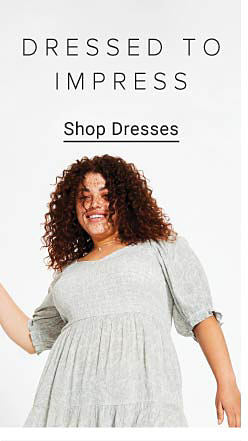 Woman wearing a light grey patterned dress. Dressed to impress. Shop dresses.