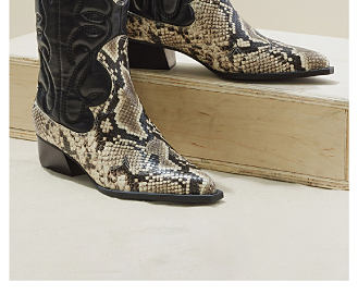 An image of snakeskin, knee high boots. Shop boots.