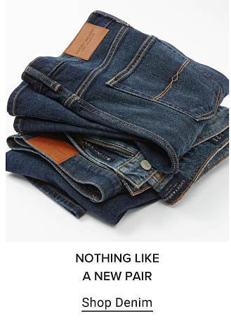 A stack of folded denim. Nothing like a new pair. Shop denim.