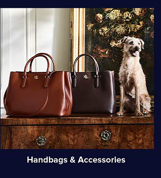 An image of two brown handbags and a small dog on a table. Shop handbags and accessories.