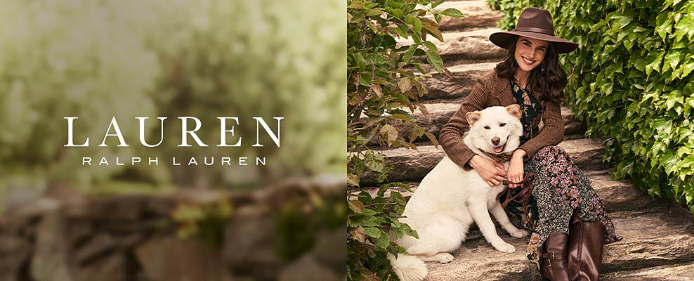 An image of a woman in a brown leather hat, brown jacket and floral dress with a white dog. Lauren Ralph Lauren.