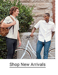 Two young men in button down shirts and jeans. Shop new arrivals.