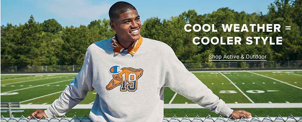 A young man in a Champion sweatshirt over an orange collared shirt. Cool weather equals cooler style. Shop active and outdoor.