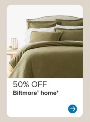 Image of a bed with green bedding. 50% off Biltmore home.