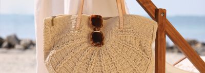 Vacation & Travel Purses. Image of beach bag & sunglasses with beach background.