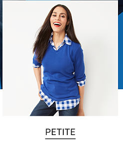 A woman in a blue and white shirt with a blue sweater on top and jeans. Shop petite.