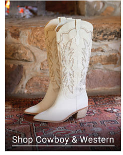 A pair of white cowboy boots. Shop Cowboy and Western