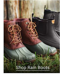 A pair of green and red duck boots next to a pair of black rainboots. Shop Rain Boots