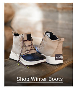 A pair of beige, black and white Sorel boots. Shop Winter Boots