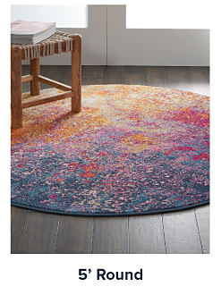 A round rug with red and blue designs. Shop 5 foot round rugs.