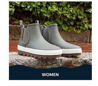 A pair of ankle-high rubber boots. Shop women.