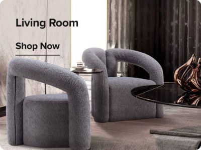 Two grey arm chairs, a side table, and lamp. Shop living room furniture.