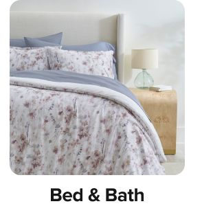 A bed with patterned bedding. Shop bed and bath.