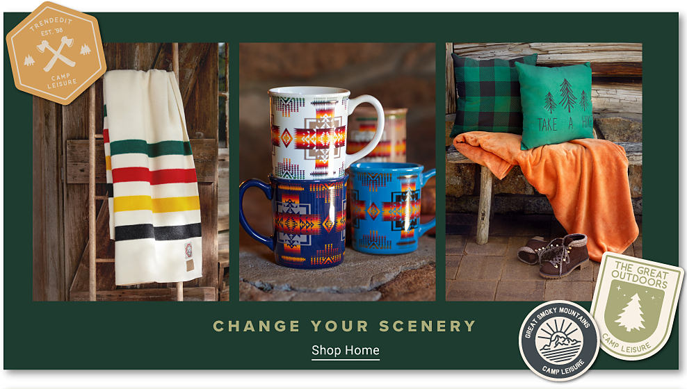 Three graphic national park style badges. An off white towel with green, red, yellow and black stripes. A collection of coffee mugs with tribal prints. Two green throw pillows an orange throw blanket and a pair of brown boots. Change your scenery. Shop home.