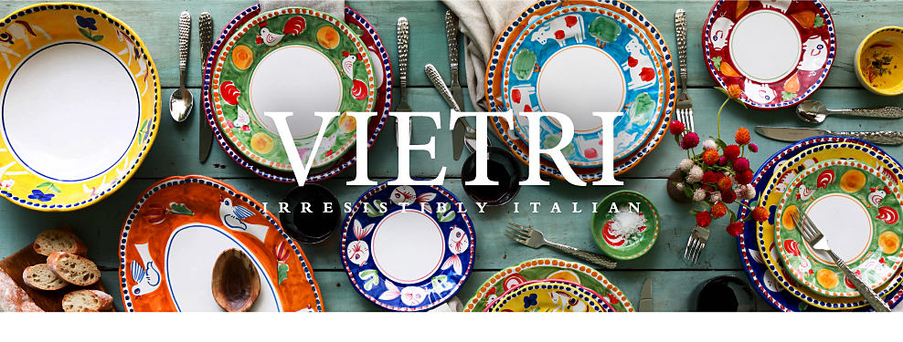 An assortment of plates and serving dishes in vibrant colors and patterns with farm animals on them. Vietri. Irresistibly Italian. 