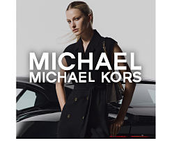 A woman wearing a black Michael Michael Kors outfit. Shop Michael Michael Kors.