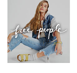 A woman wearing a denim jacket, jeans and sandals with tall socks. Shop Free People.