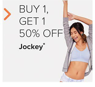 Woman wearing a light blue sports bra and grey hoodie. Buy 1, get 1 50% off Jockey. 