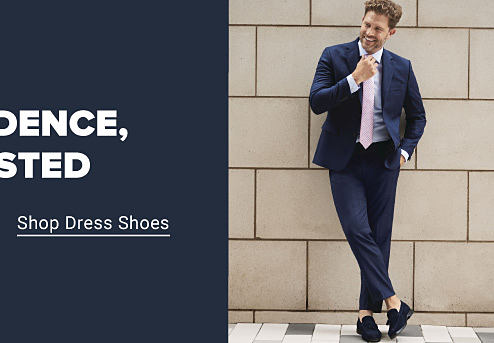Shop dress shoes. A man in a blue suit.