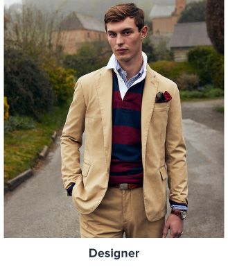 A man in a tan sports coat, a striped shirt and khaki pants. Shop designer.