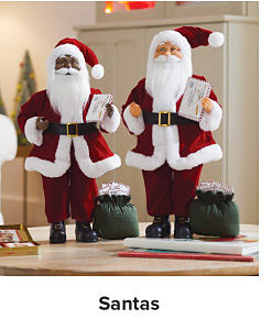 Two Santa figurines. Shop Santas.