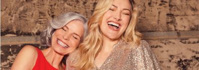 Her. Image of two women laughing.