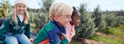 Kids. Image of three kids outside.