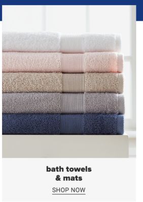 A stack of folded towels in a variety of colors. Bath towels and mats. Shop now.