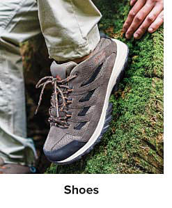 A brown and black hiking shoe. Shop shoes.
