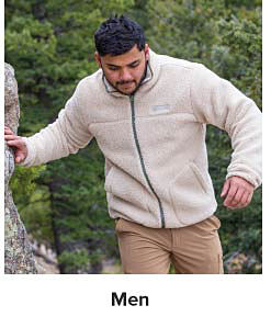 A man wearing an off white zip front fleece jacket and khaki colored hiking pants. Shop men.