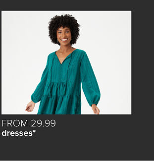 Woman wearing a teal peasant dress. From $29.99 dresses. 