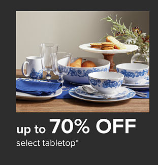 White plates and bowls with blue floral detailing. Up to 70% off select tabletop.