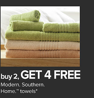 Stack of green, beige and brown towels. Buy 2, get 4 free Modern Southern Home towels.