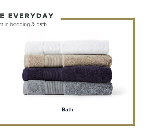 Four folded towels in white, brown, blue and gray. Shop bath. 