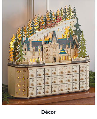 A wooden advent calendar with a cutout of the Biltmore Estate on it. Shop decor.