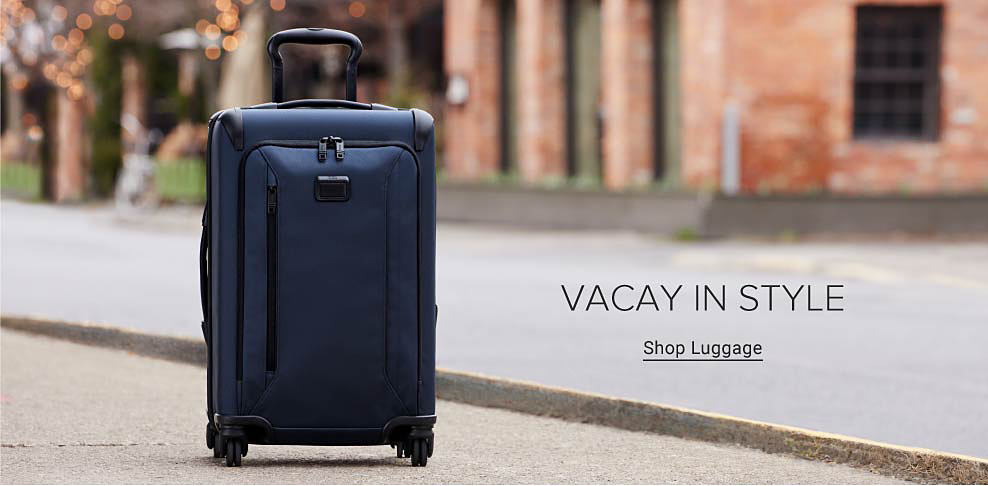 Image of a navy blue suitcase. Vacay in style. Shop luggage.