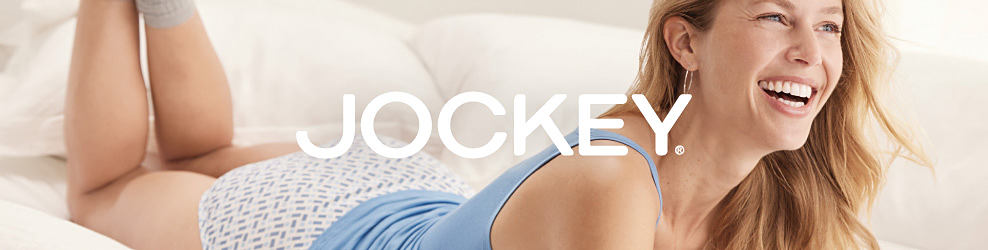 Image of a woman wearing a light blue tank top and white patterned underwear. Jockey logo. 