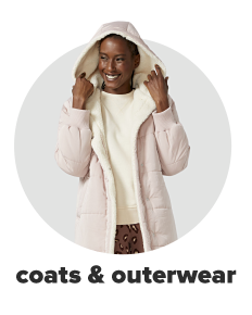 A woman wears a sherpa coat over a white top paired with leopard-print leggings. Shop coats and outerwear.