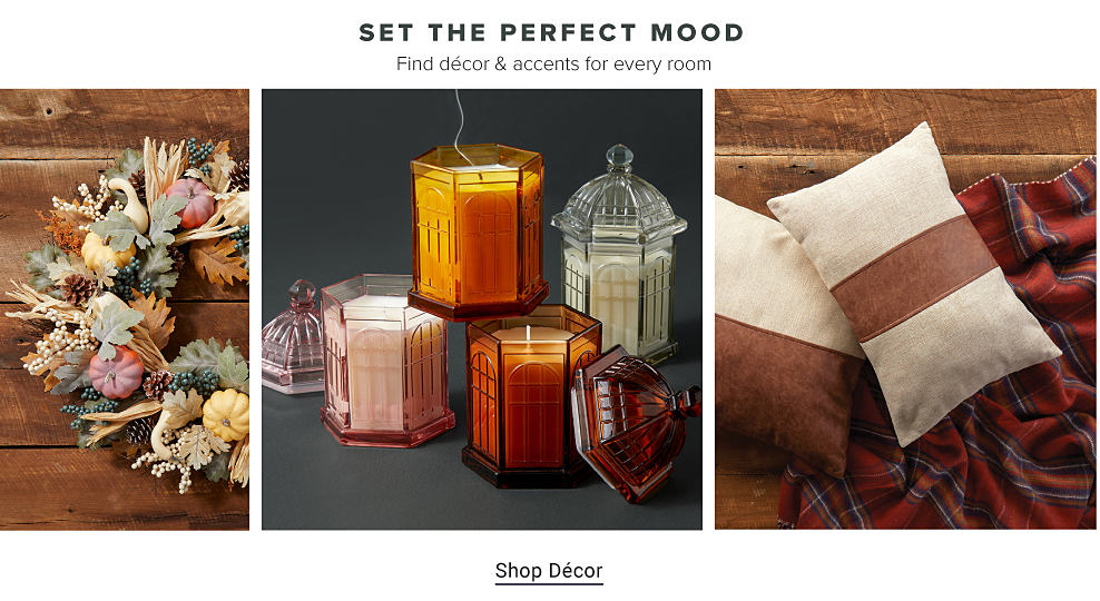 Set the perfect mood. Find decor and accents for every room. A wreath with autumnal flowers, pumpkins and gourds. Candles in orange glass containers. White and brown pillows on top of a red plaid blanket. Shop decor.