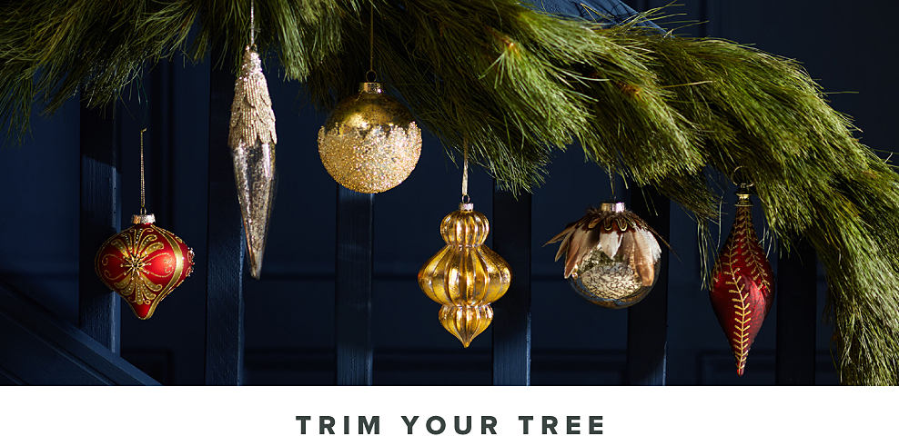 Image of tree branch with ornaments. Trim Your Tree.