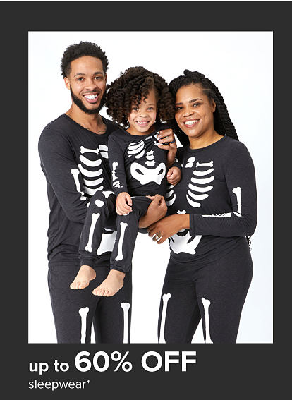 Family wearing matching skeleton pajama sets. Up to 60% off sleepwear.