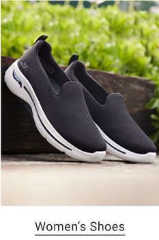 A pair of black slip-on sneakers with a white sole. Shop women's shoes.