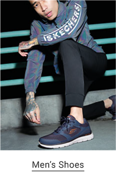 A man wears a long-sleeve Skechers top paired with black pants and dark lace-up sneakers. Shop men's shoes